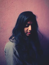 Beautiful woman standing against wall