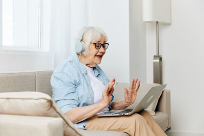 Senior man using laptop while sitting at home