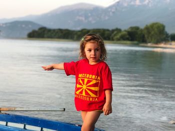 Girl pointing while traveling in boat on lake