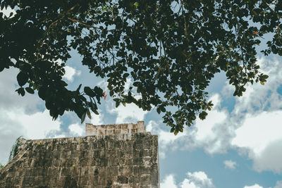 Low angle view of fort against cloudy sky