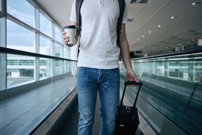 Rear view of man standing on glass