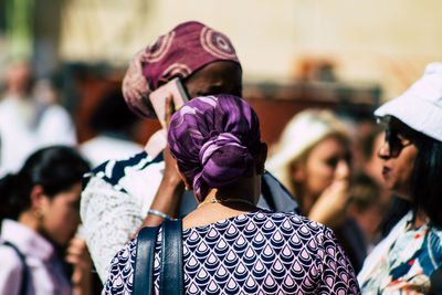 Rear view of women standing outdoors