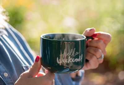 Midsection of woman holding coffee