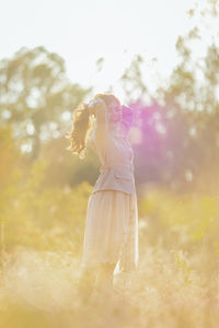 Side view of woman standing on field