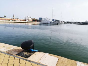 Sailboats moored at harbor