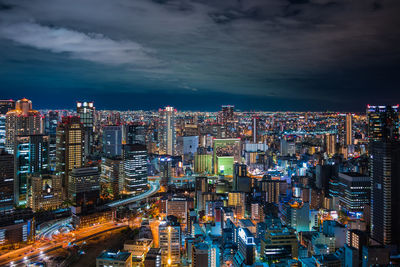 High angle view of illuminated city buildings at night