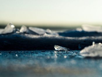 Close-up of snow on sea against sky