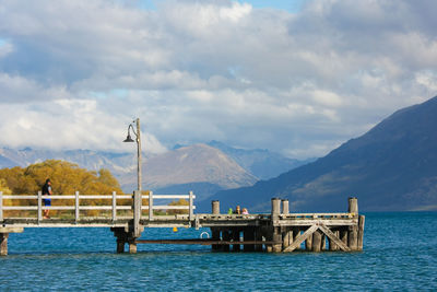 Pier over sea against mountains