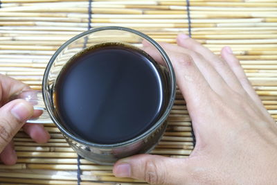 Directly above shot of woman holding coffee cup