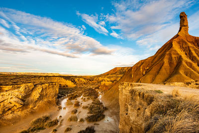 View of rock formations against cloudy sky