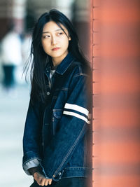 Portrait of young woman standing on snow