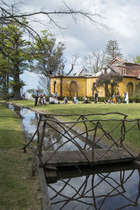 Group of people in park against buildings