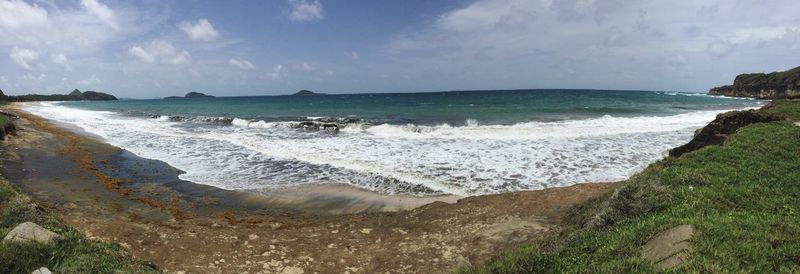 Panoramic view of beach against cloudy sky