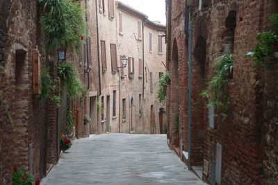 Footpath amidst buildings in city