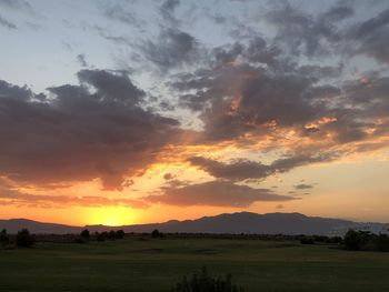 Scenic view of field against sky during sunset