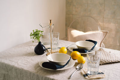 Vintage table setting with linen napkins and yellow lemons.