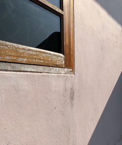 Low angle view of window on wall of building