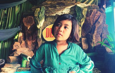 Portrait of young woman sitting outdoors