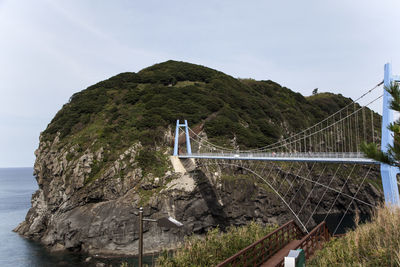 Hardanger bridge by mountain over sea
