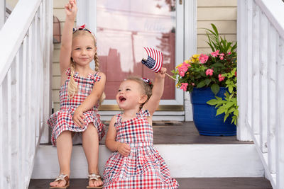 Happy girl smiling women standing against wall