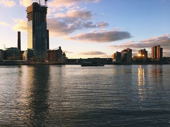 City at waterfront during sunset