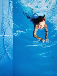 Side view of woman swimming in pool