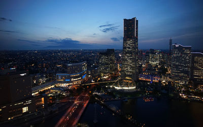 High angle view of illuminated buildings against sky at night