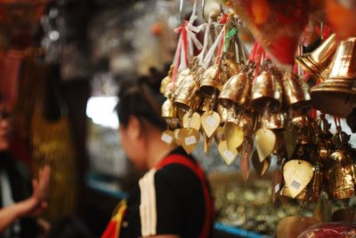 Close-up of bells hanging for sale in market