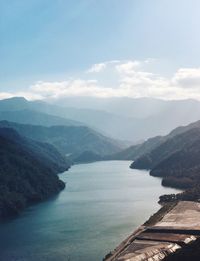 Scenic view of lake and mountains against sky