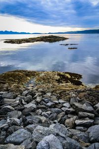 Scenic view of sea against cloudy sky