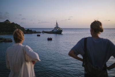 Rear view of women looking at sea