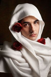 Portrait of man wearing headscarf on black background