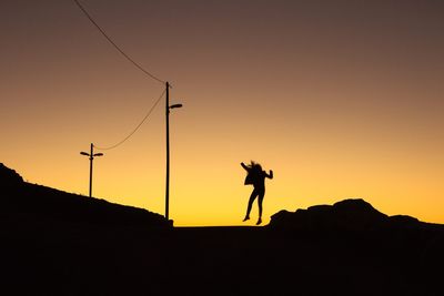 Silhouette of woman at sunset