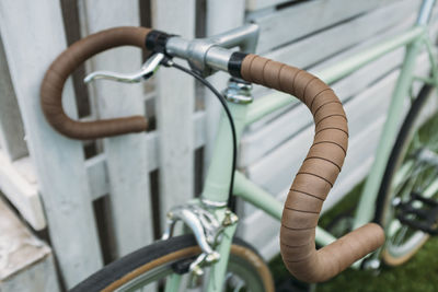 High angle view of bicycle parked by wooden fence