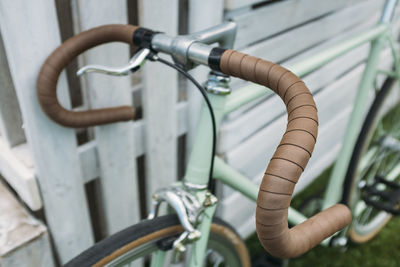 Close-up of bicycle wheel against wall