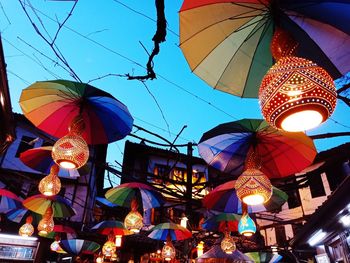 Low angle view of illuminated lanterns hanging at night