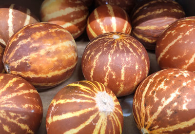 Dark orange asian melons close up. background from little melons.