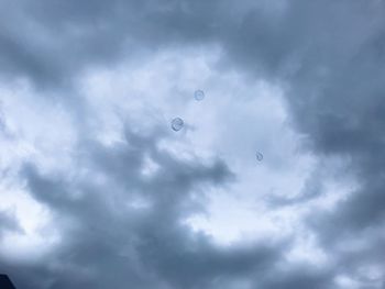 Low angle view of birds flying against sky