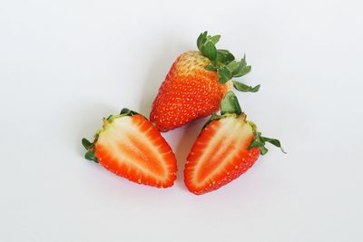 Directly above shot of chopped fruit against white background