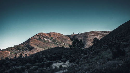 Scenic view of mountains against clear blue sky