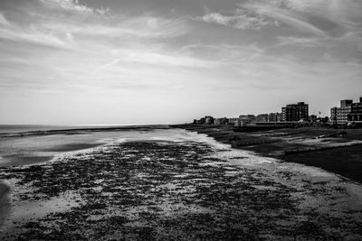 Scenic view of sea against sky in city