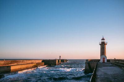 Scenic view of lighthouse by the ocean