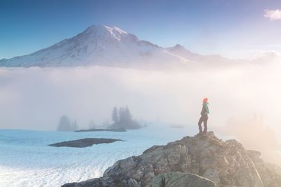 Man standing on rocks against mountain