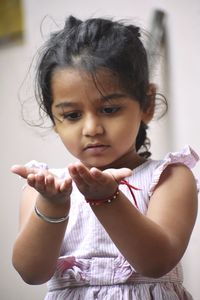 A baby girl washing hand