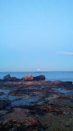 Scenic view of sea against clear blue sky