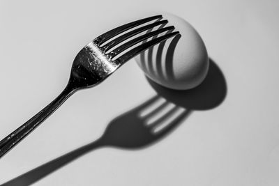 Close-up of fork over white background