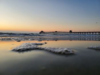 Scenic view of sea against clear sky during sunset