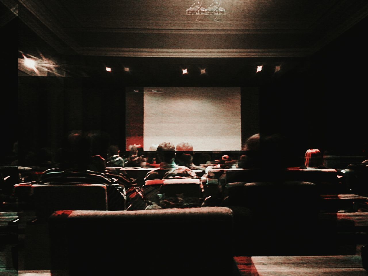 VIEW OF PEOPLE SITTING IN CHAIRS