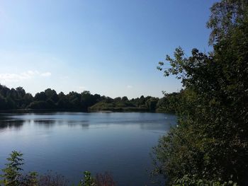 Scenic view of lake against clear blue sky