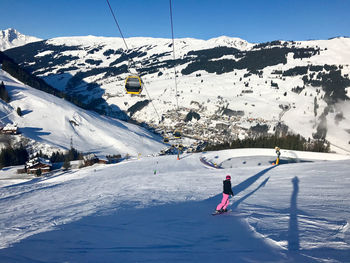 Woman snowboarding on snowcapped mountain